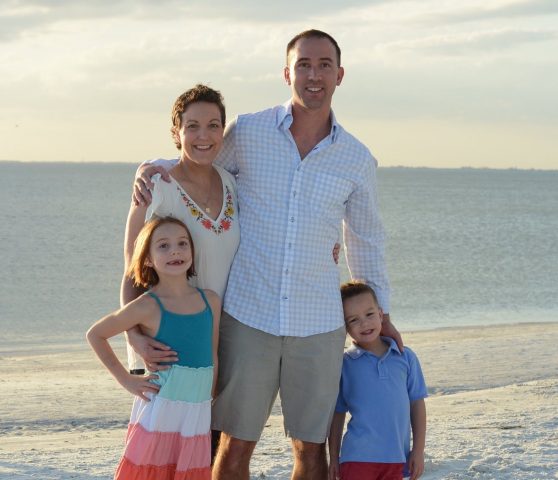 Marce Lamontagne with her husband Justin and their kids at the beach with the ocean behind them