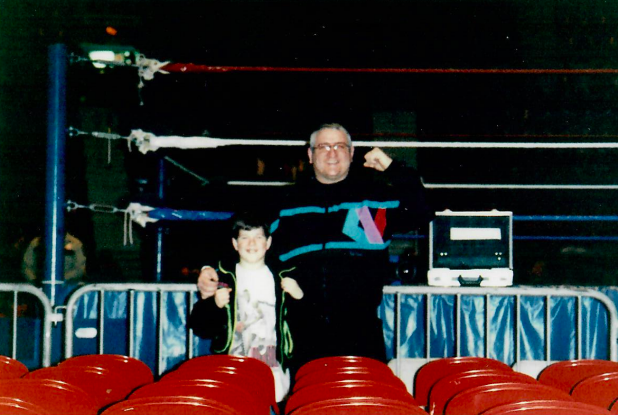 Don Heidorn and his son at a wrestling event back in the day in front of an empty ring