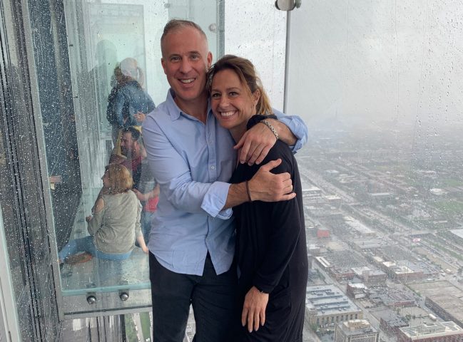Dave and Debbie on the sky deck overlooking the cityscape