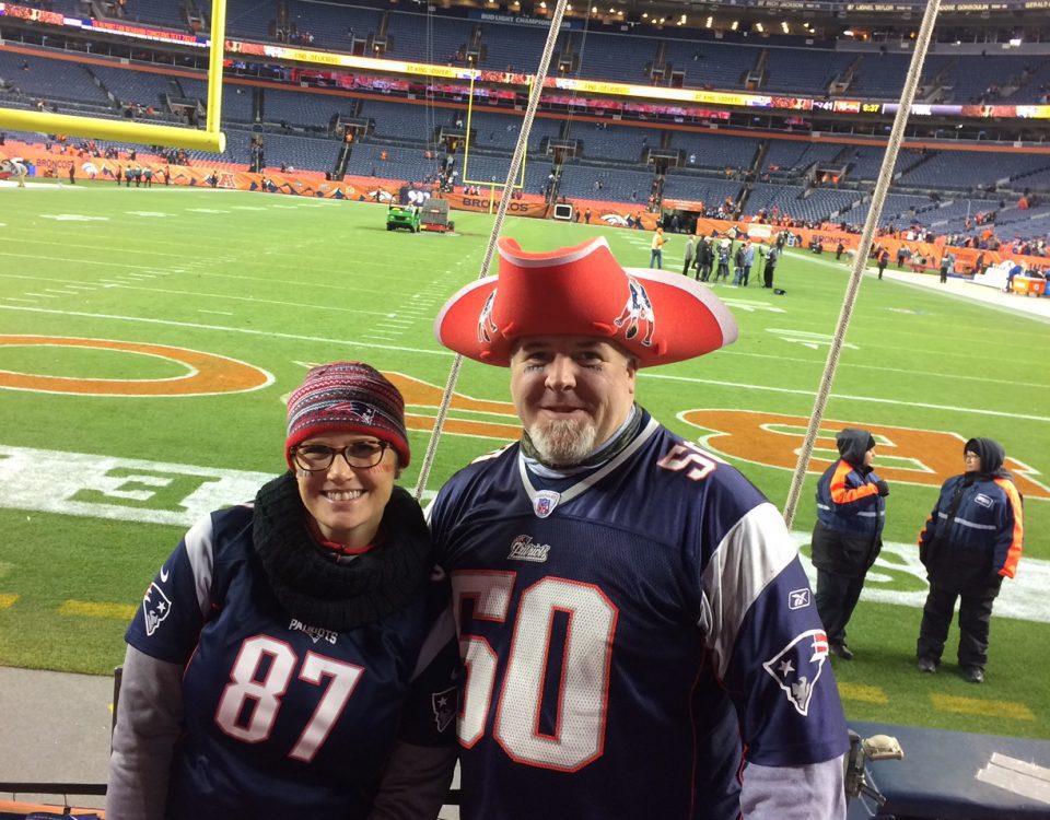 Erica Hendry and husband at Mile High Stadium wearing Patriots jerseys and gear