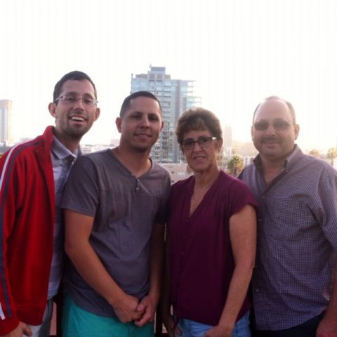 Doreen Meisch with her husband and sons with a cityscape in the background