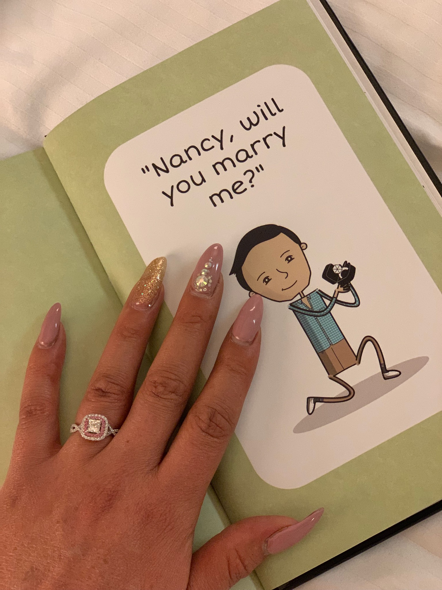 picture of cartoon book asking, 'Nancy, will you marry me?'