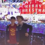 Christy Fjellman and her daughter in front of Christmas lights