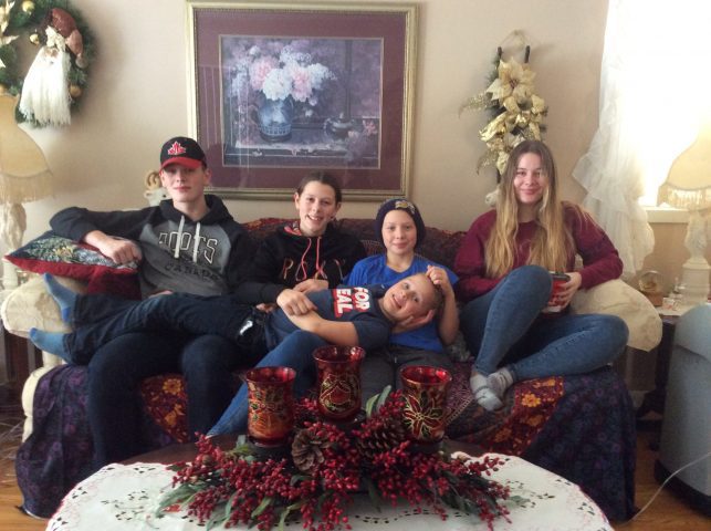 the davidson kids sitting on the couch together