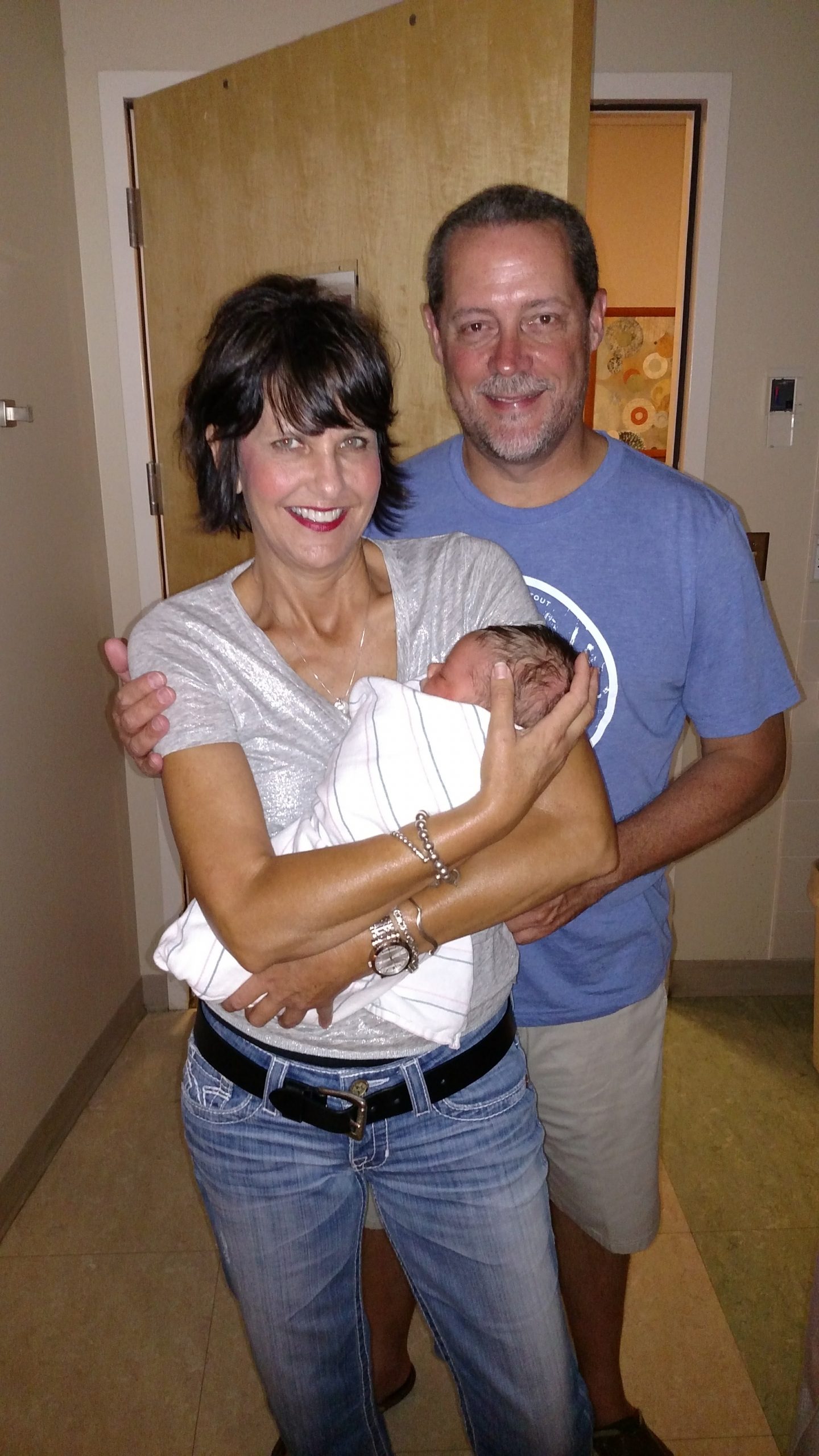 Patti Beaudoin with husband holding newborn baby in the hospital