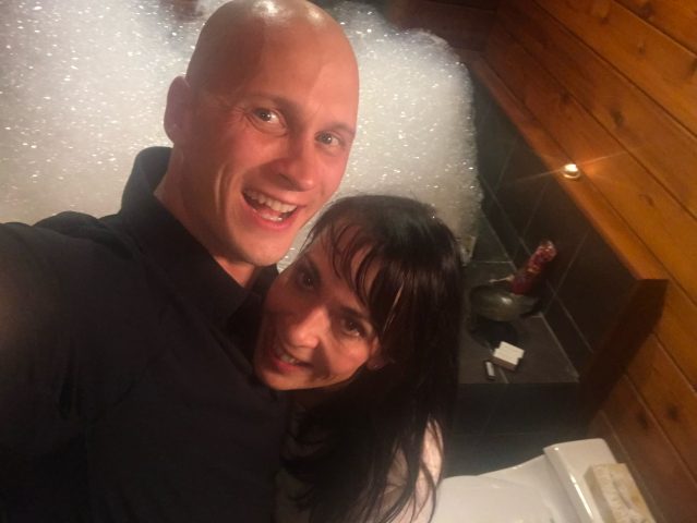 Christina Duprat and her husband in front of a giant bubblebath