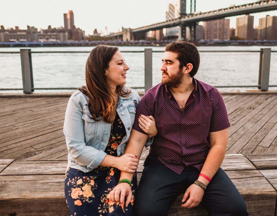 Josh Terc and Dallis Vargas looking into each other's eyes with the city in the background