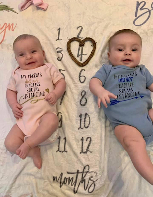 Megan's twins wearing matching "My parents did not practice social distancing" shirts celebrating their 4th month on earth