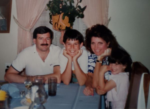 Cheryle Kouser with her husband and children at the dinner table back in the day