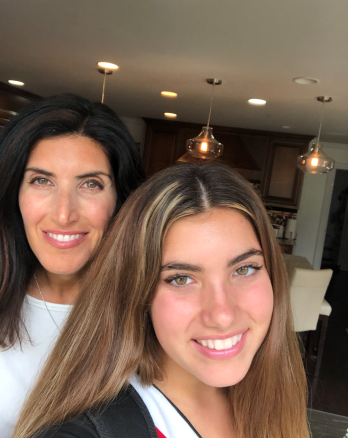 Carly Rezac and her mom smiling wide in their living room