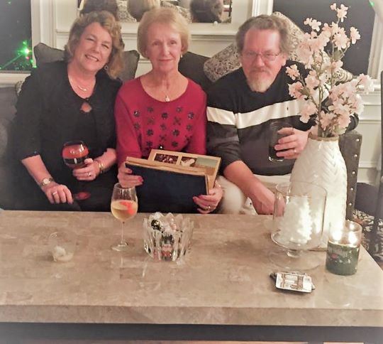 Susan Spurling and her two siblings sitting at a coffee table