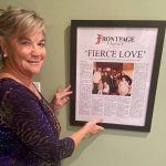 Ross Tucker's mom Sandee with her framed newspaper story in her townhouse