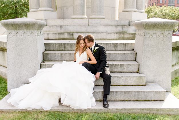 Tyler and Brooke on the stone steps in their wedding suit and wedding dress on their wedding day