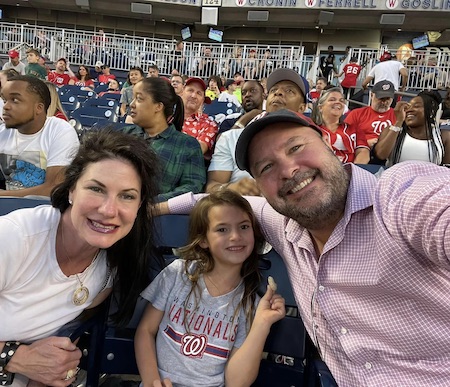 Michele Flynn with her husband and daughter at a Washington Nationals baseball game