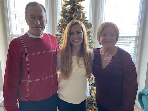 Doug Gotwalt with his wife and his daughter in front of a Christmas tree
