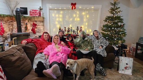 Jordan Berndt hanging with her husband and family in front of the Christmas tree