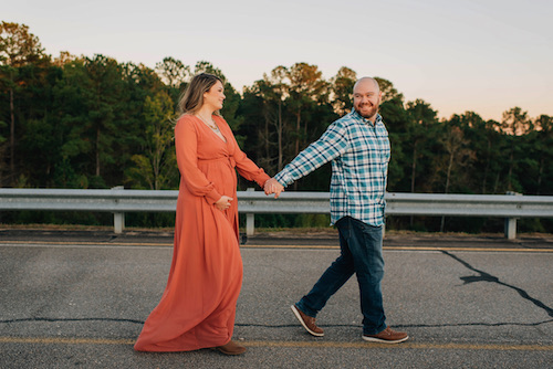 Hannah Flanagan and Kyle walking on the road for a photo shoot while she's pregnant