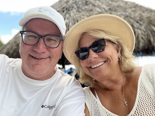 Beth Collins and her husband smiling on the beach
