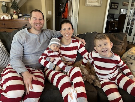 Sarah Chapman with her husband and children wearing matching maroon and white striped pajamas