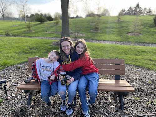 Pamela Mueller and her kids sitting on the park bench in the fall