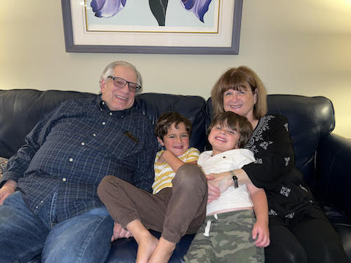 Cheryl Lynn Altman with her husband and grandchildren on the couch