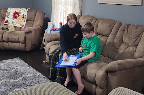 Ricki Keil's son and daughter playing a game on the couch together
