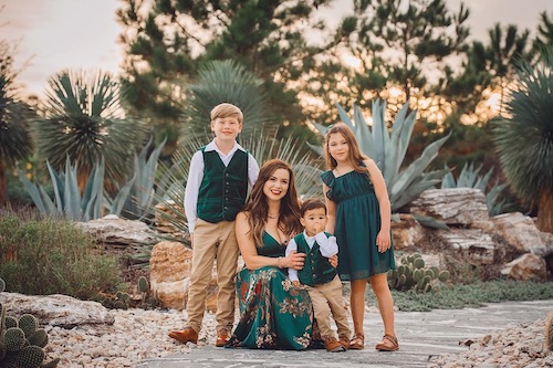 Anais and her kids dressed up for a family portrait in the bushes