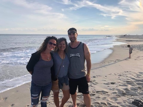 Trish Donald and her kids in the sand by the ocean