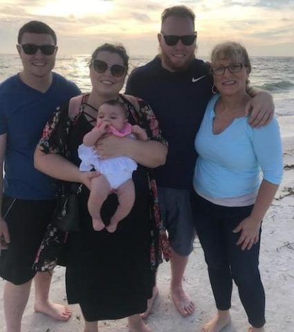 Brenda Myers and her family hanging out by the ocean at the beach