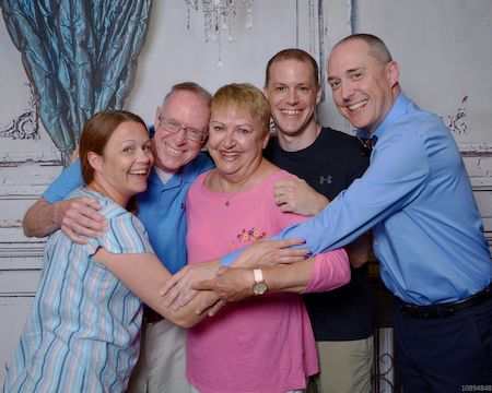Sheila Shepard taking a family photo with her three kids and husband