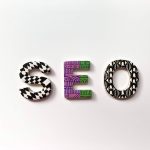 A colorful image with magnets that spell out SEO for Search Engine Optimization