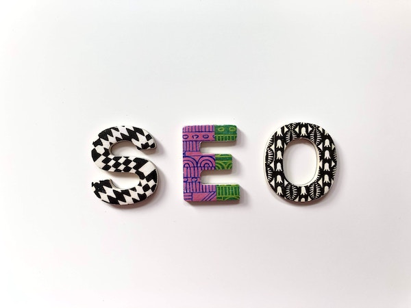 A colorful image with magnets that spell out SEO for Search Engine Optimization