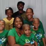 The Rowland family mostly wearing matching green shirts