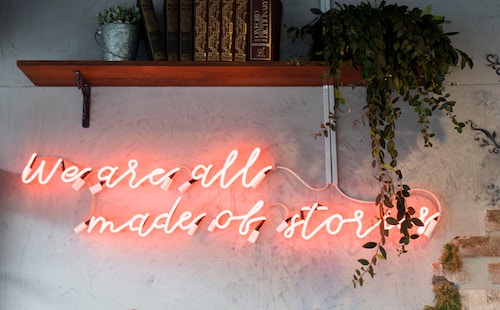 Neon sign that says 'we are all made of stories'