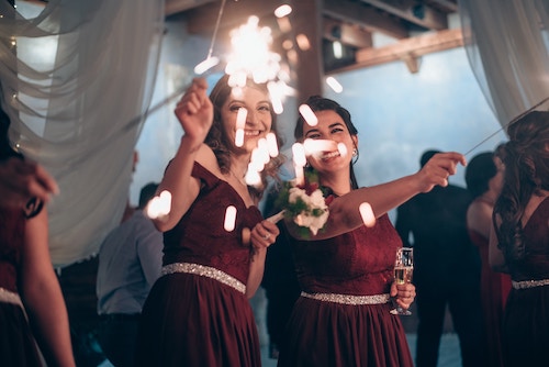 sparklers and champagne being held during a wedding reception celebration