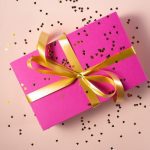 pink gift wrapped with a gold bow