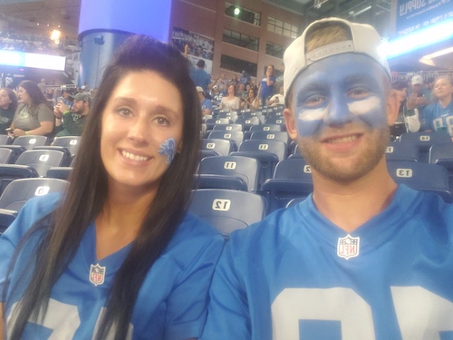 Kylie and River Boyd at a Lions game in throwback jerseys