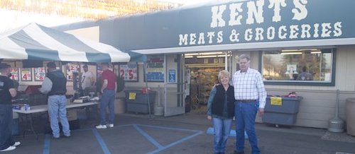 Kent and Kathy Pfrimmer in front of Kent's Meat & Groceries