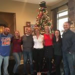 Cindy Bassett and the family in front of a Christmas tree